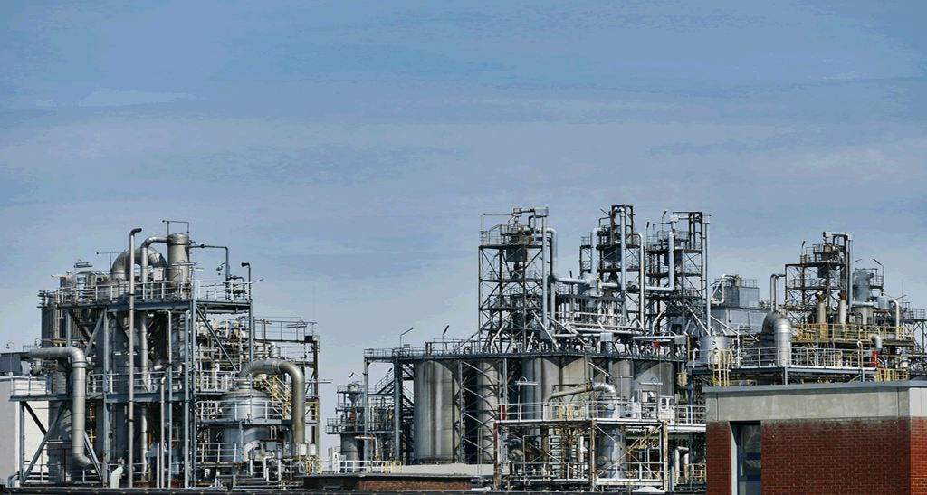 Industrial processing facility under a blue sky